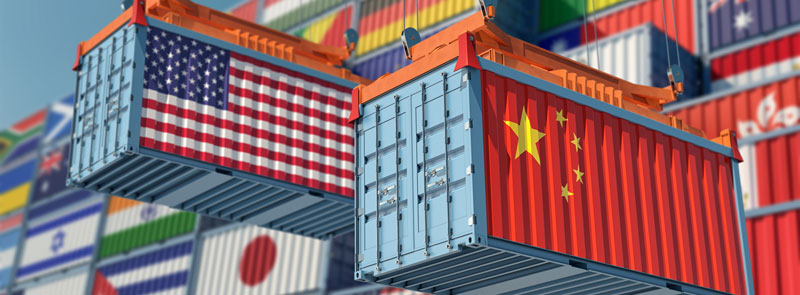 Containers with country flags being moved around a ship yard