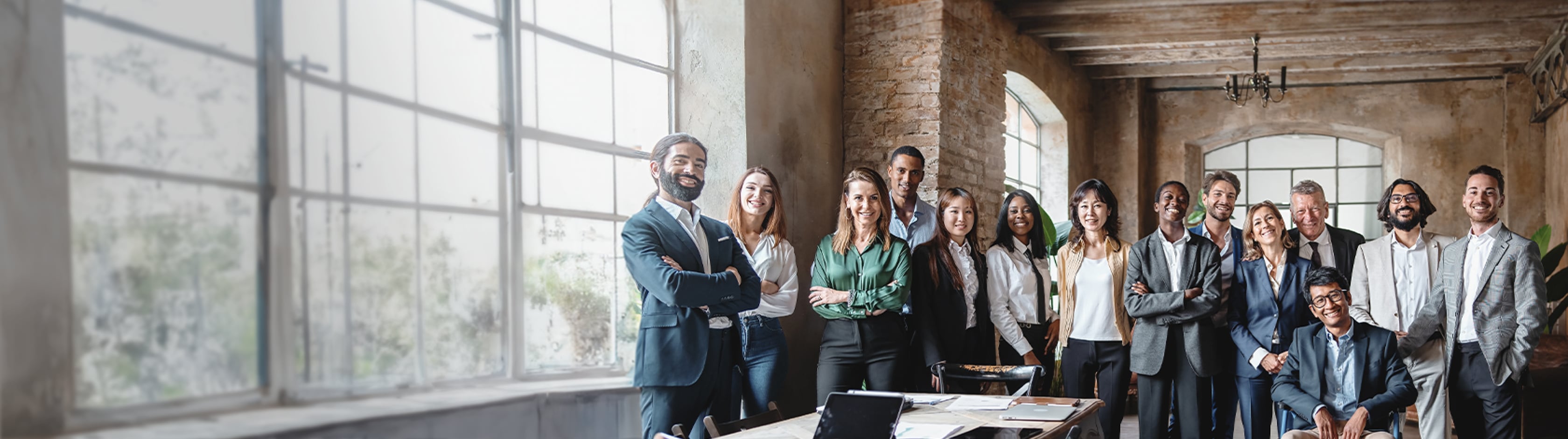 Diverse group of people in a group photo together in an office