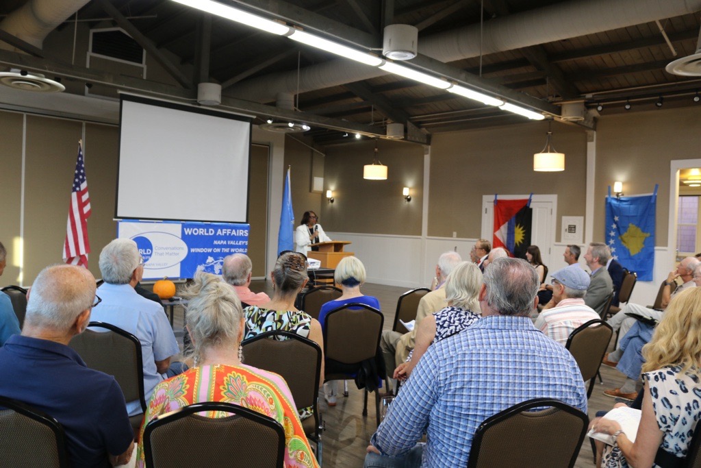 Chair Reta Jo Lewis speaking to a room of people