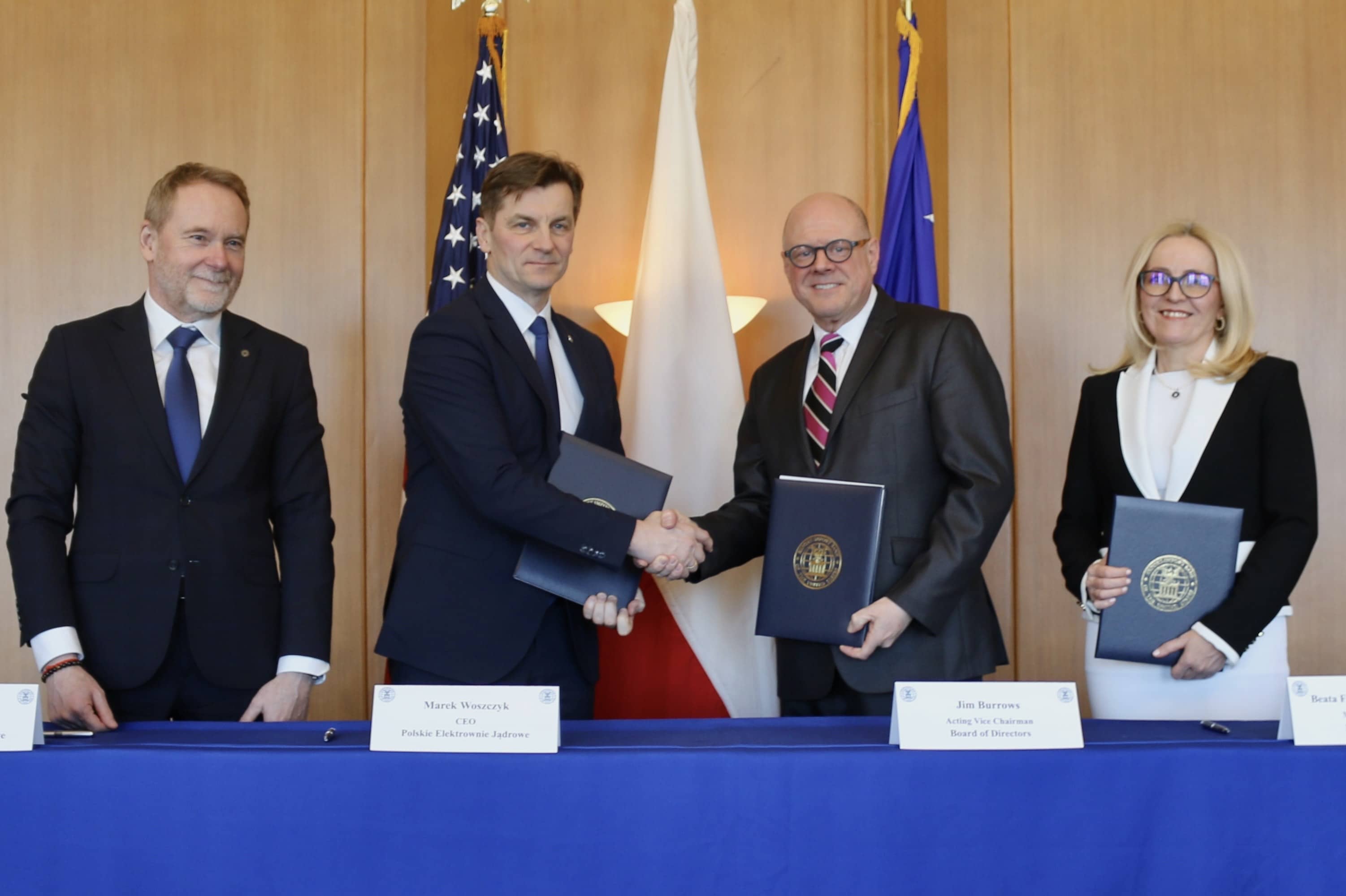 Dignataries on stage shaking hands