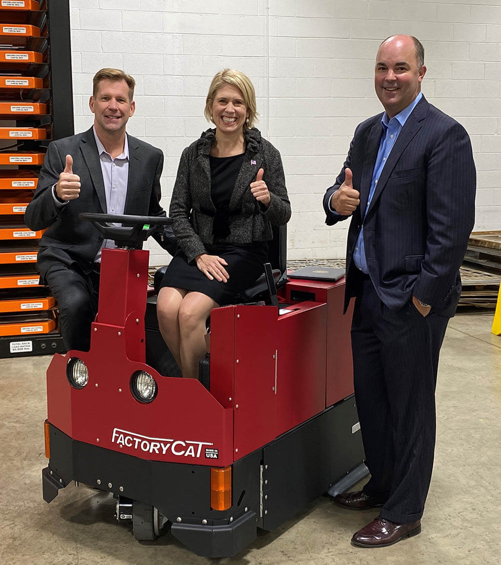 From left: RPS Corporation CIO Marc McDuffie; EXIM Chairman Reed; and RPS Corporation CFO Pete Jedlicka on a RPS Factory Cat Floor Sweeper to be exported to Denmark using EXIM's export credit insurance.